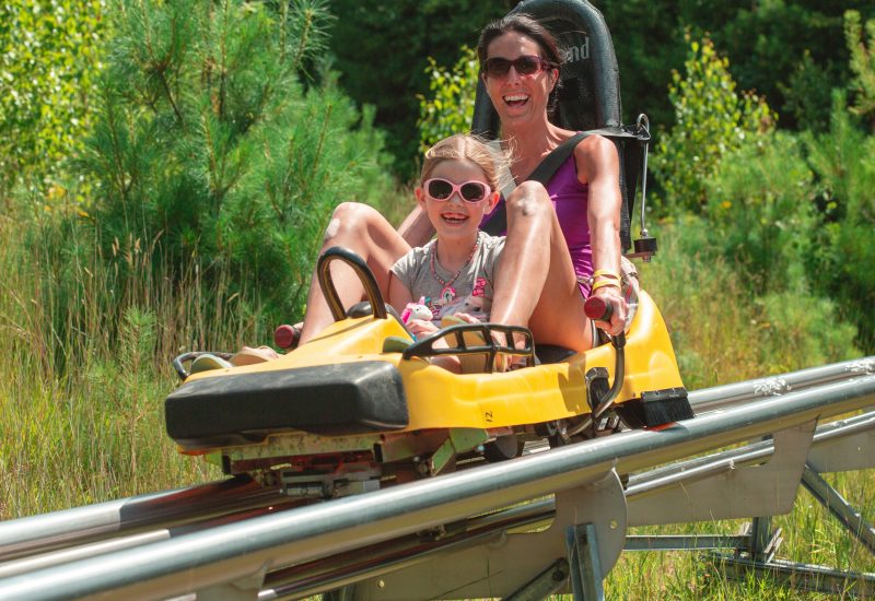 Mother and daughter on mountain coaster