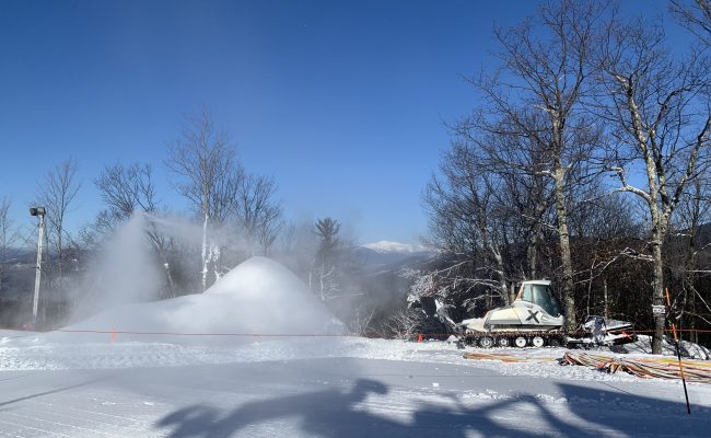Snowmaking and Grooming equipment top of Cranmore Mt Washington in background