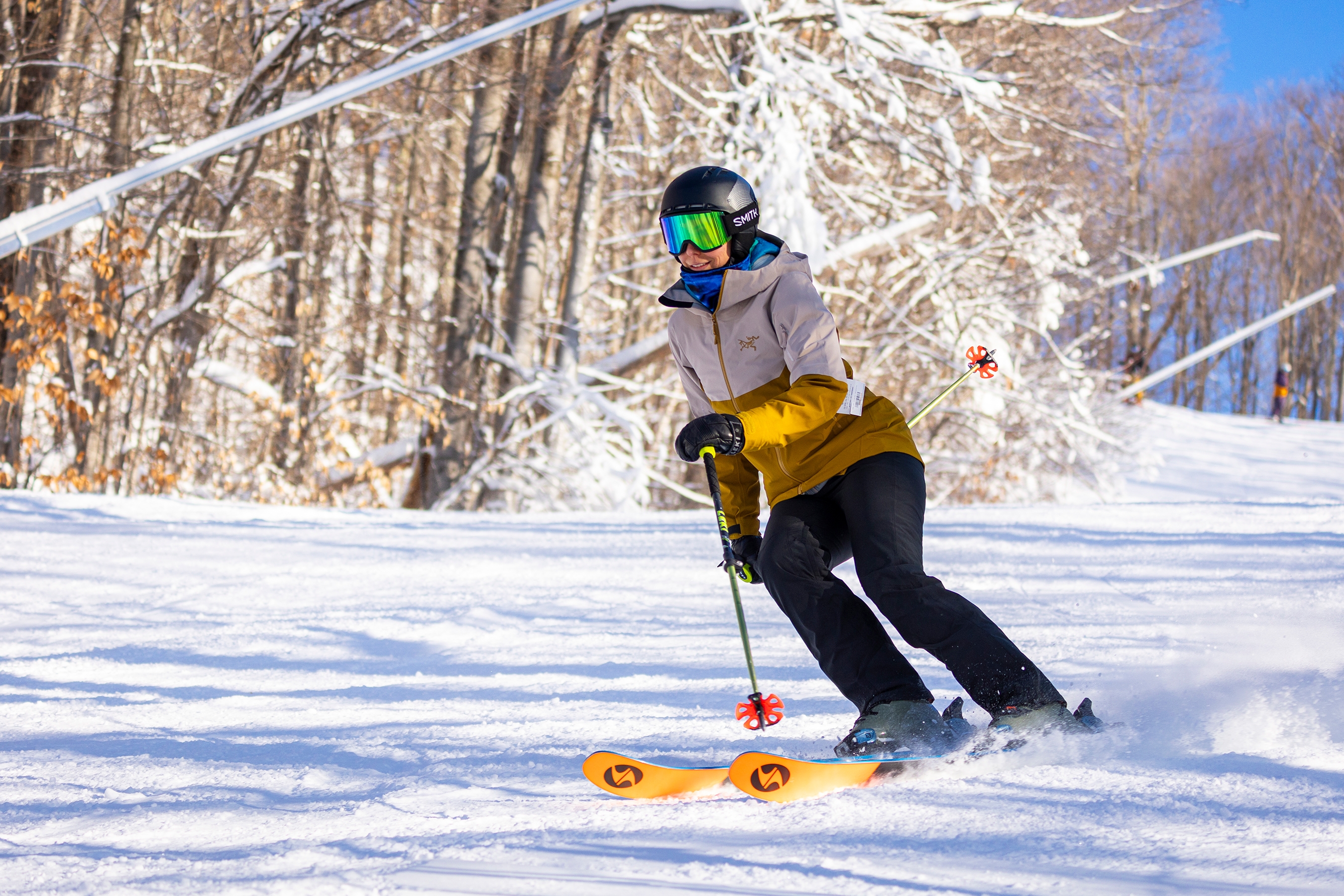 Skier in Gold Arc'teryx Jacket making pole plant